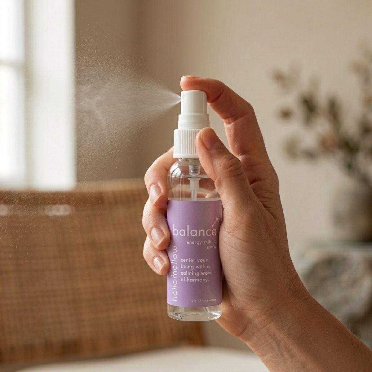 hand spraying a fine mist from the balance energy shifting spray bottle