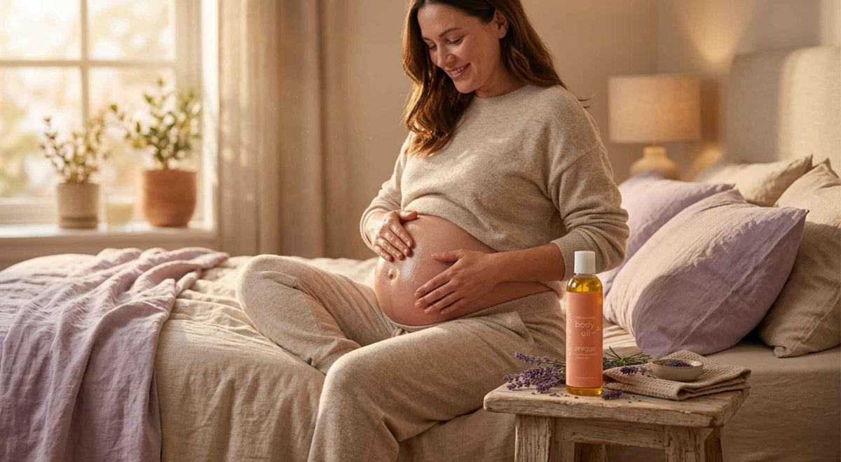 pregnant woman massaging body oil into her belly for soft, moisturized stretching skin