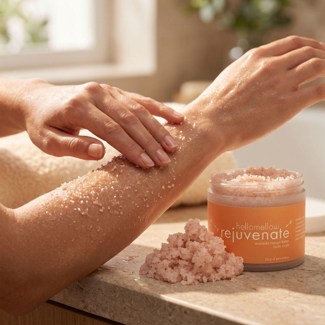 hands massaging rejuvenate body scrub onto damp skin in gentle circular motions