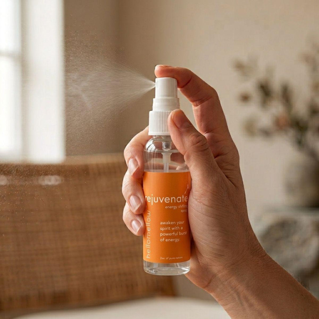 hand spraying a fine mist from the rejuvenate energy shifting spray bottle