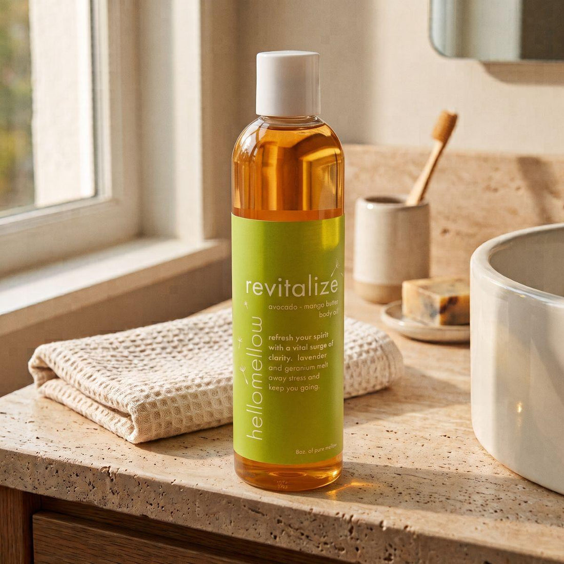 uplift body oil on a warm bathroom counter beside a folded towel