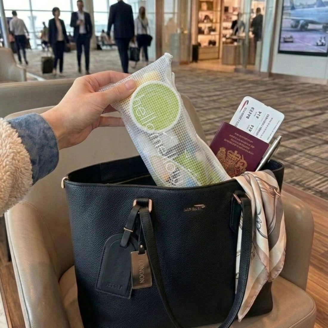 revitalize vacay vibe travel bodycare set inside of a purse at the airport