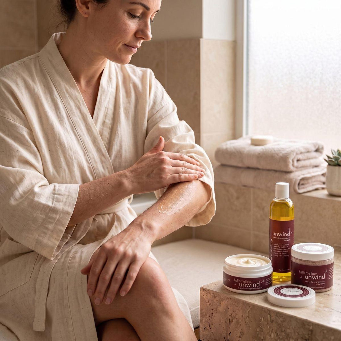woman applying the body butter from an unwind essential routine