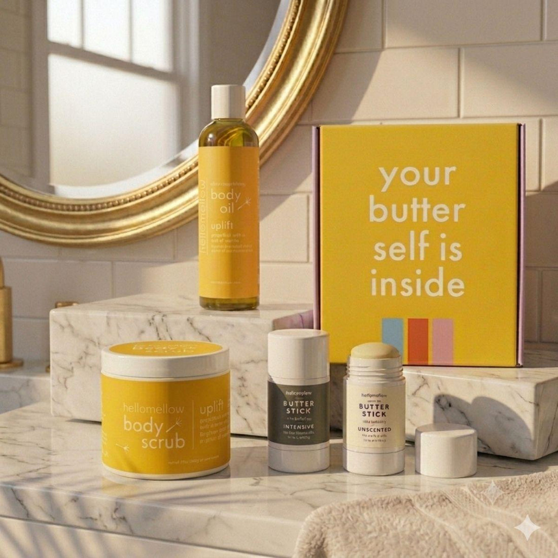 uplift essential routine on marble countertop body oil, body scrub, and body butter stick duo