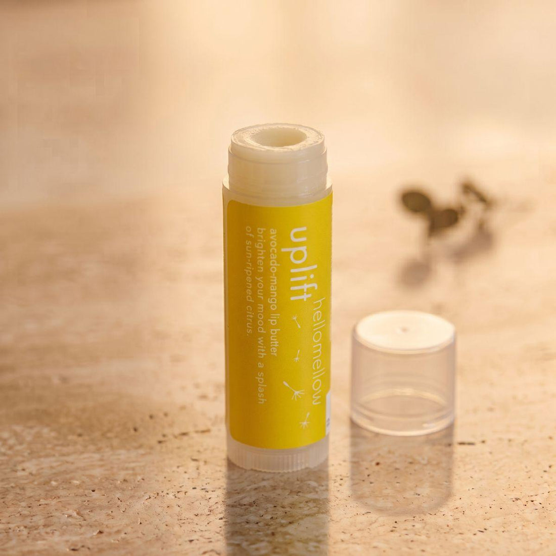 uplift lip butter shown open or ready for use in its real packaging