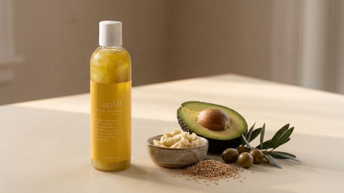 a body oil bottle stands beside two small dishes of plant butters on a warm ivory surface.