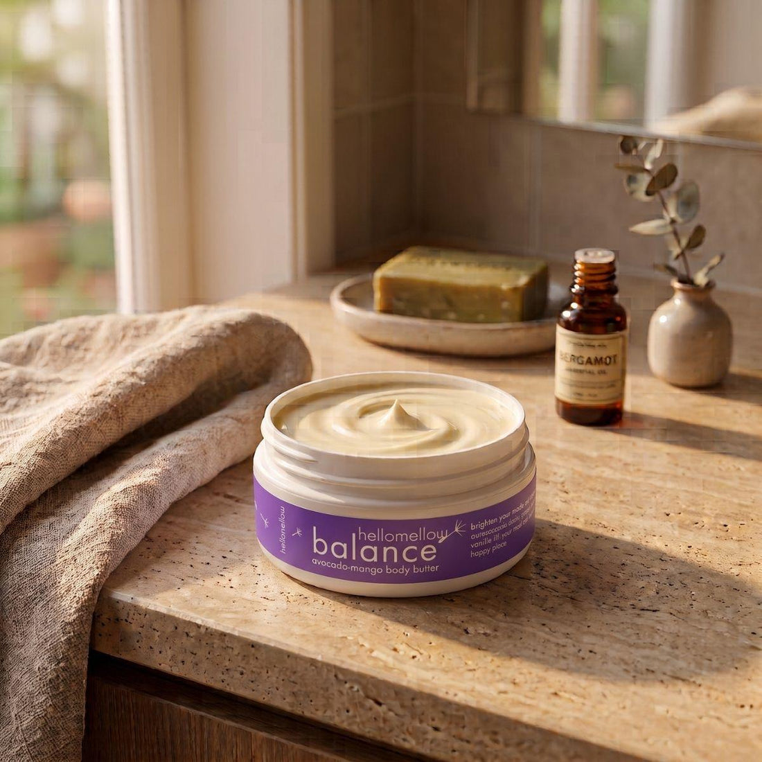 balance body butter on a warm bathroom counter beside a folded towel