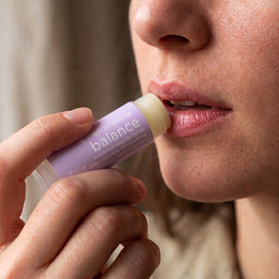 balance lip butter being applied naturally to lips in soft daylight