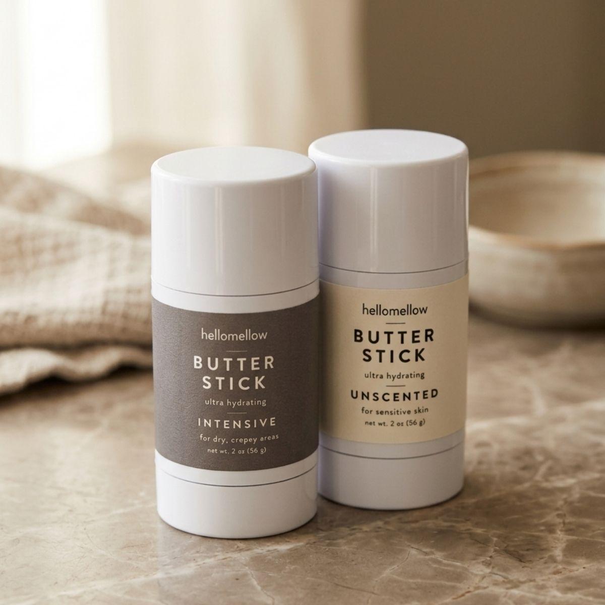 butter stick duo set one intensive butter stick one unscented butter stick on a stone countertop 