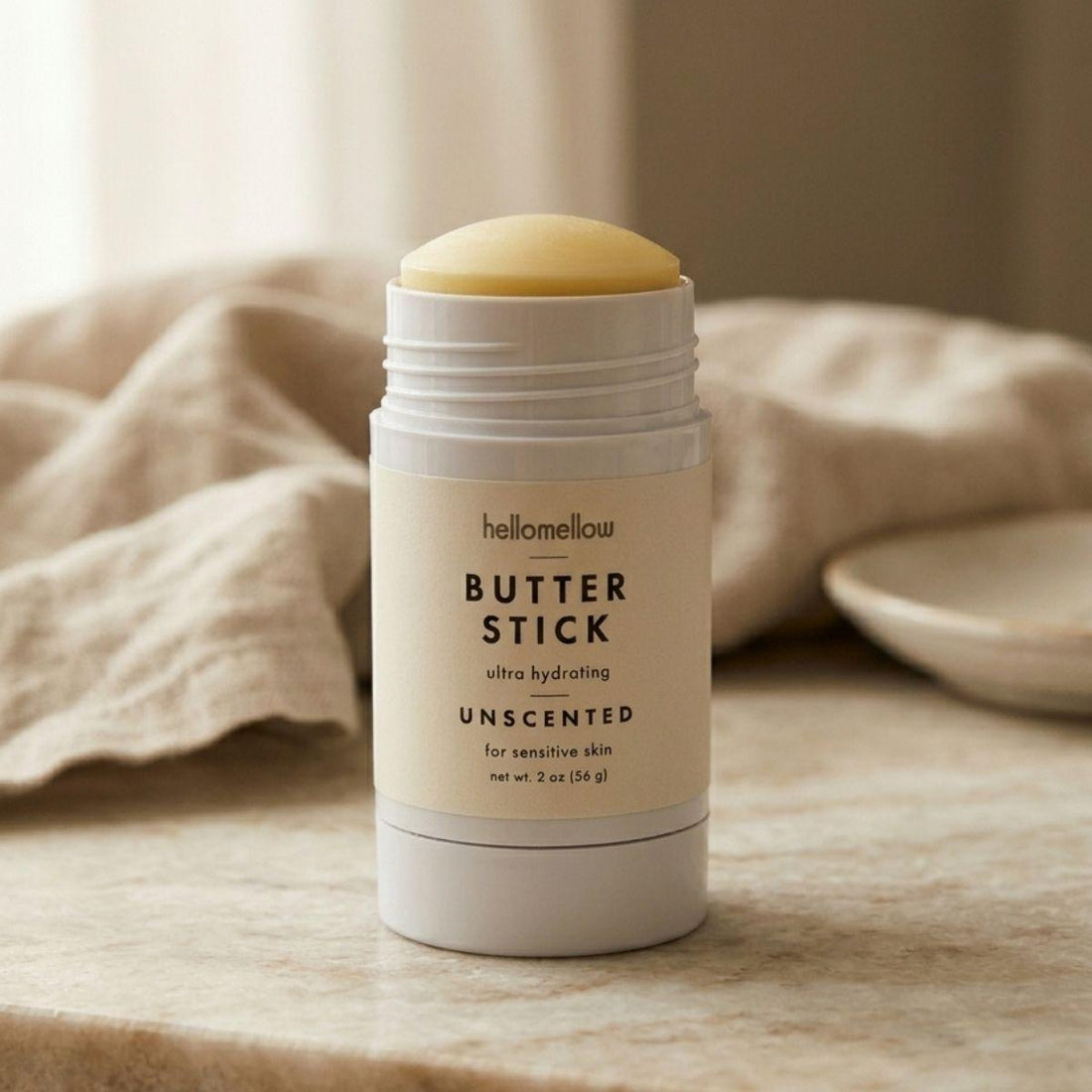 one unscented butter stick open on a stone countertop