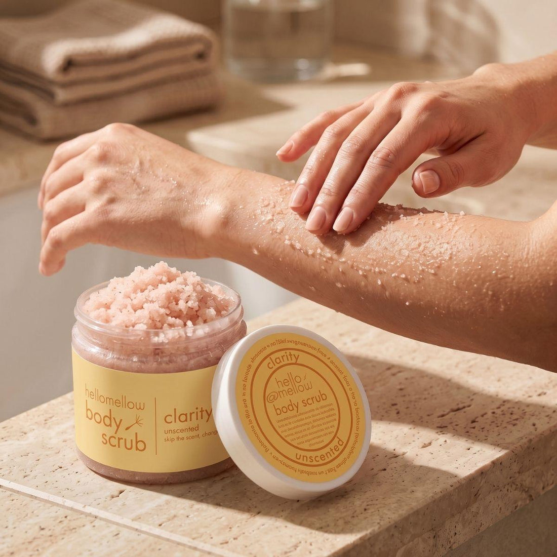 hands massaging clarity body scrub onto damp skin in gentle circular motions