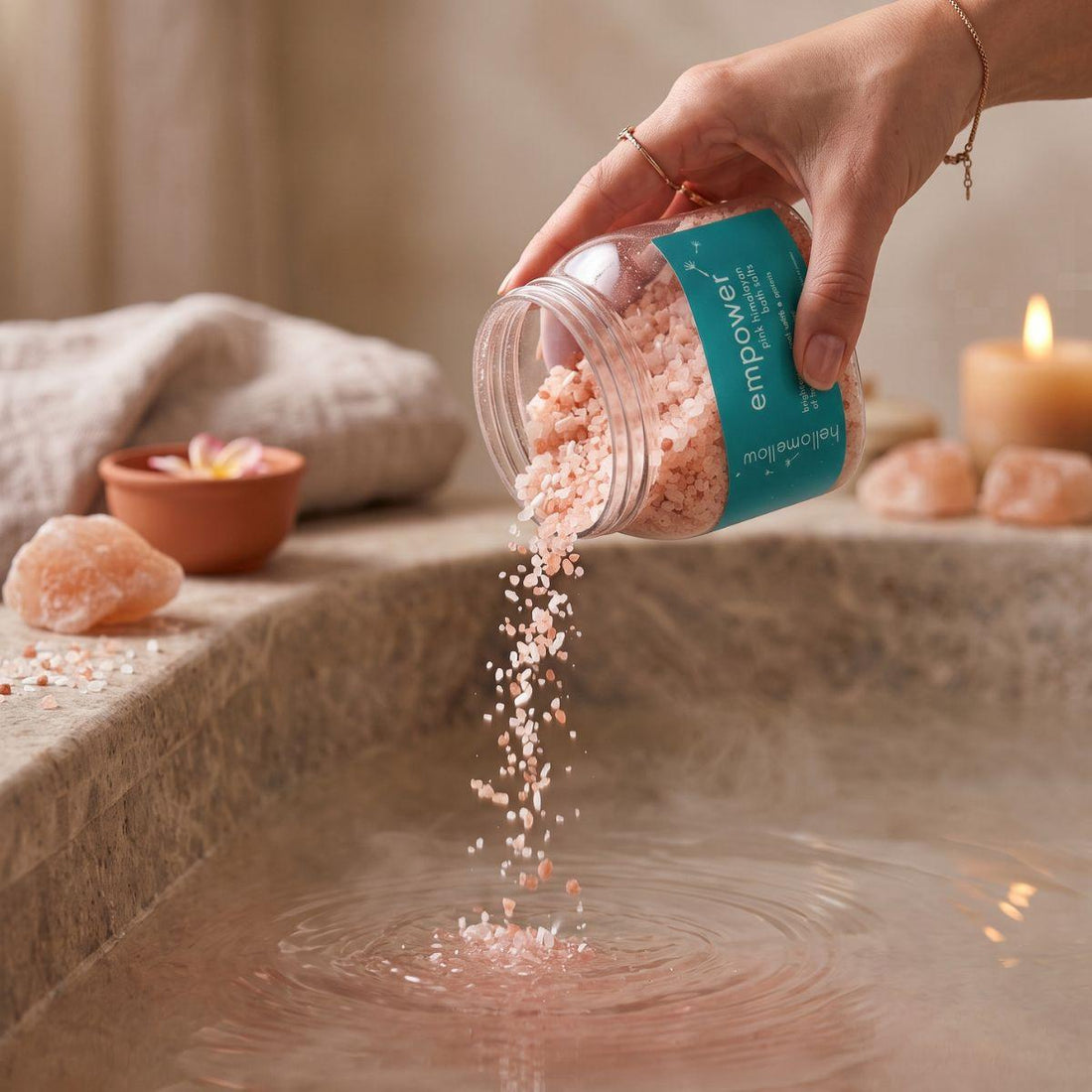 empower bath salts being poured in a small amount toward warm bath water