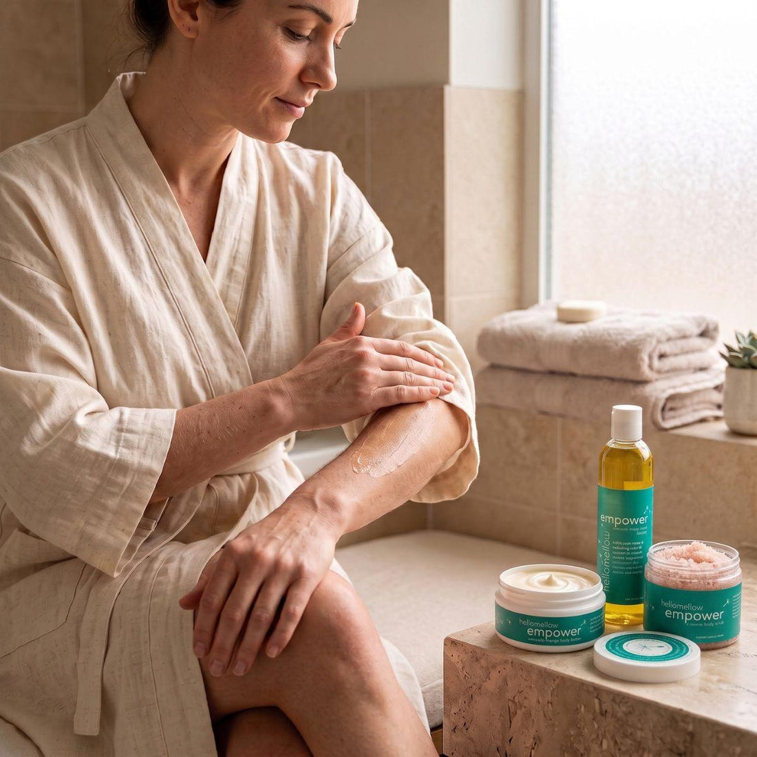 woman applying the body butter from an empower essential routine 