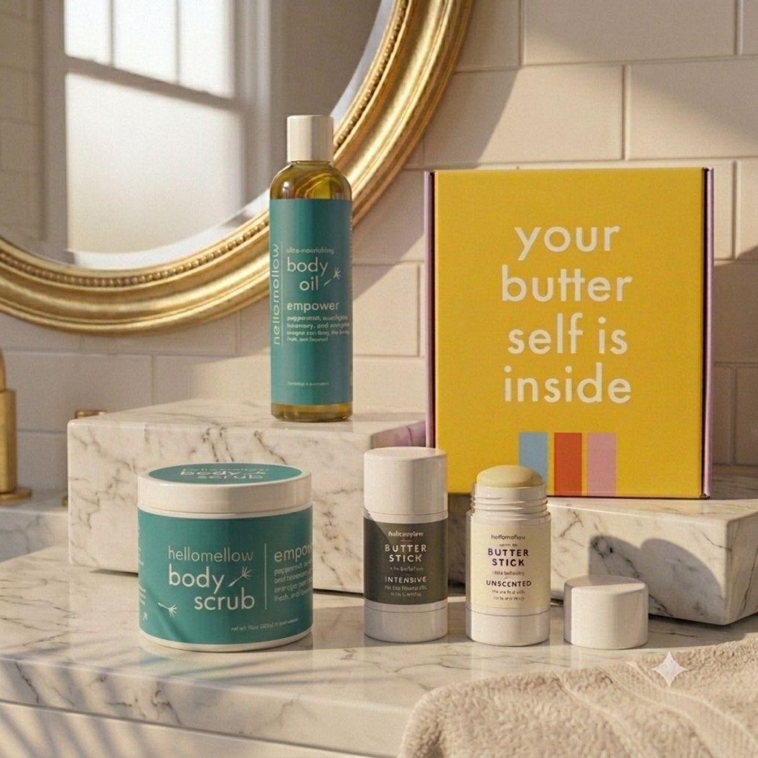 empower essential routine on marble countertop body oil, body scrub, and body butter stick duo