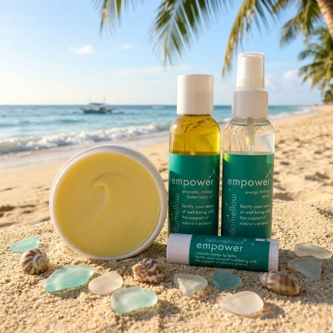 empower vacay vibe on a warm and sunny beach mini body oil, energy shifting spray, lip butter, and body butter 