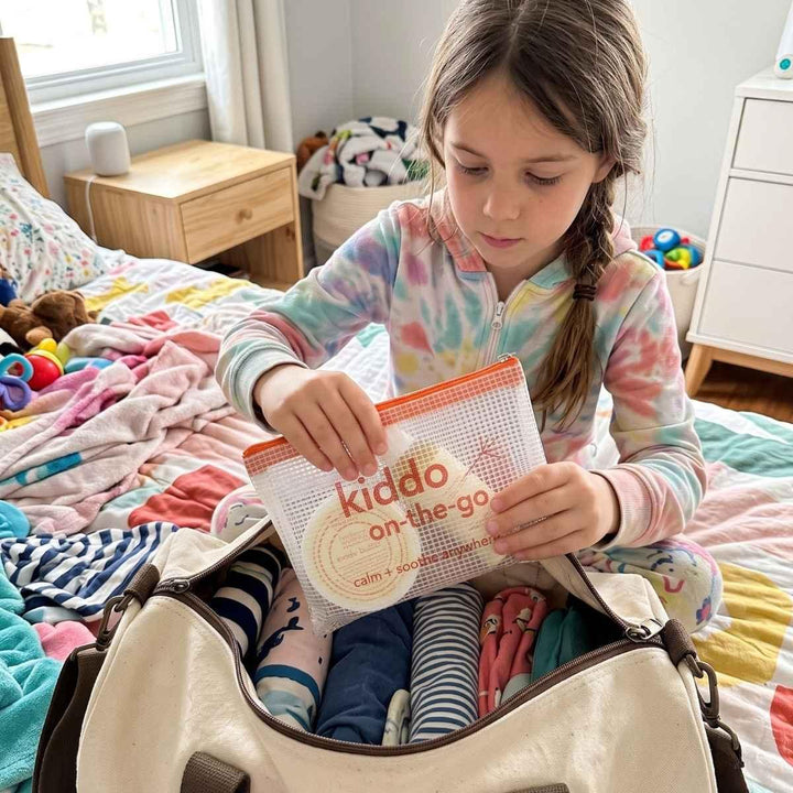 girl packing the hellomellow kiddo on the go set