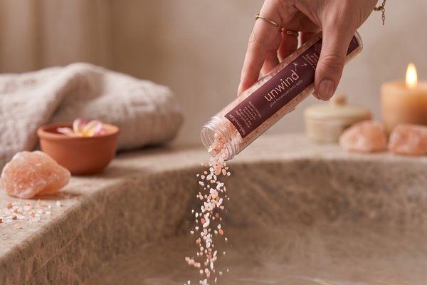 hellomellow unwind mini soak being poured into the bathtub