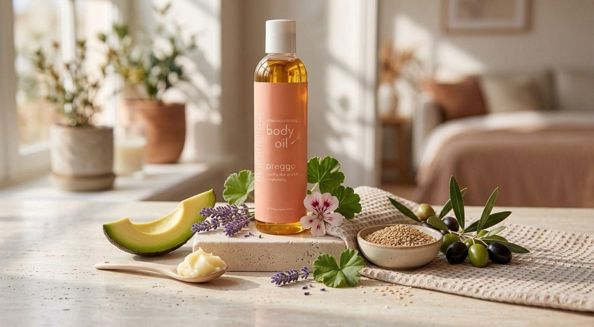 preggo body oil with plant oils, butters, lavender and geranium ingredients arranged nearby