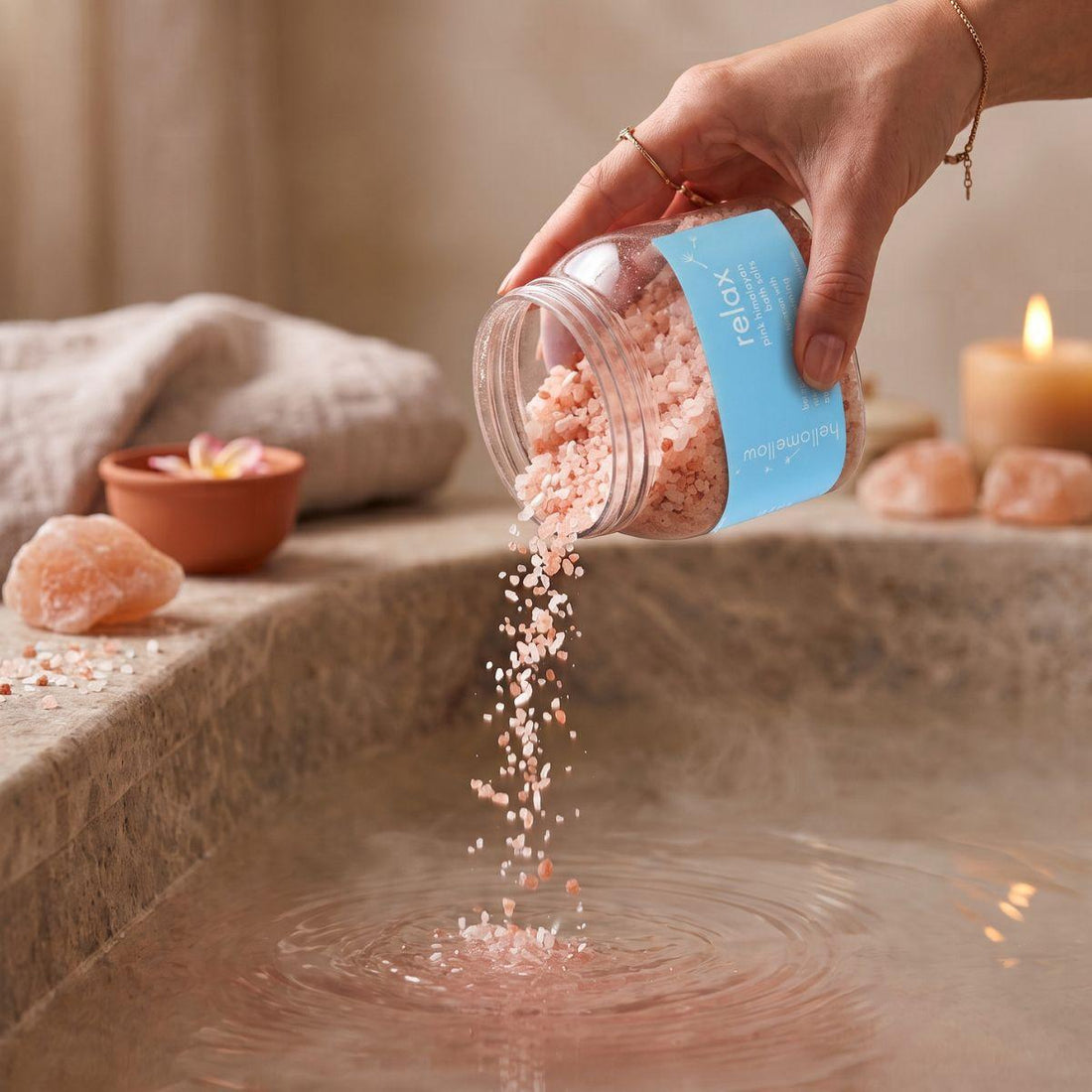 relax bath salts being poured in a small amount toward warm bath water