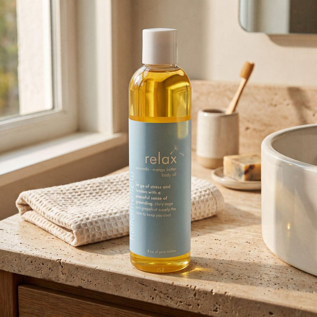 relax body oil on a warm bathroom counter beside a folded towel