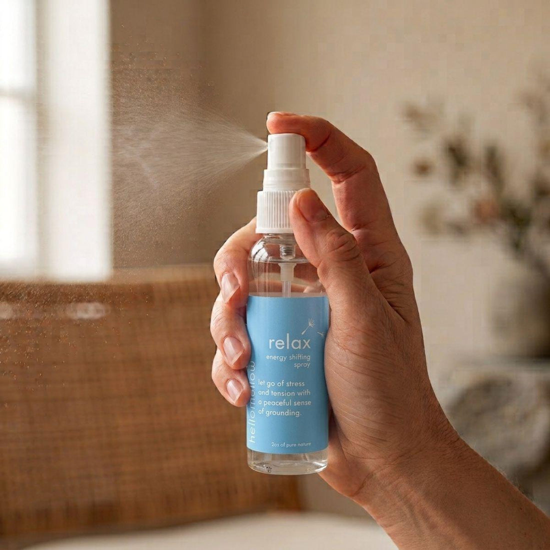 hand spraying a fine mist from the relax energy shifting spray bottle