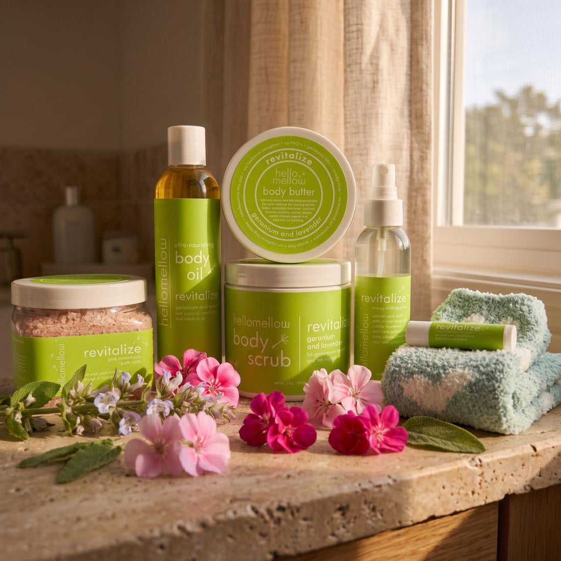 revitalize body scrub, body oil, and current butter products grouped together on a warm bathroom counter