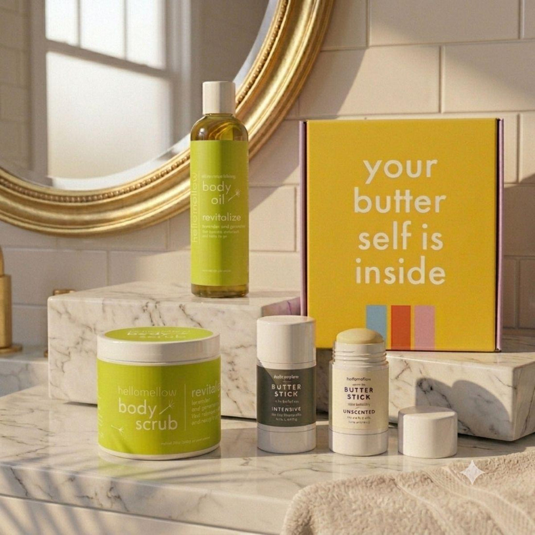 revitalize essential routine on marble countertop body oil, body scrub, and body butter stick duo