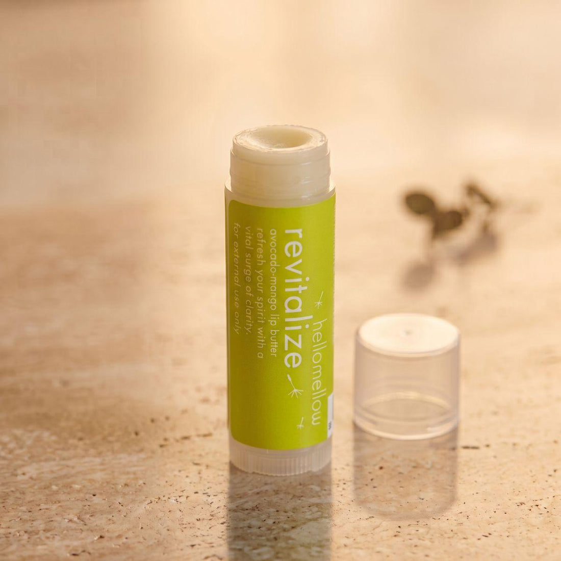 revitalize lip butter shown open or ready for use in its real packaging