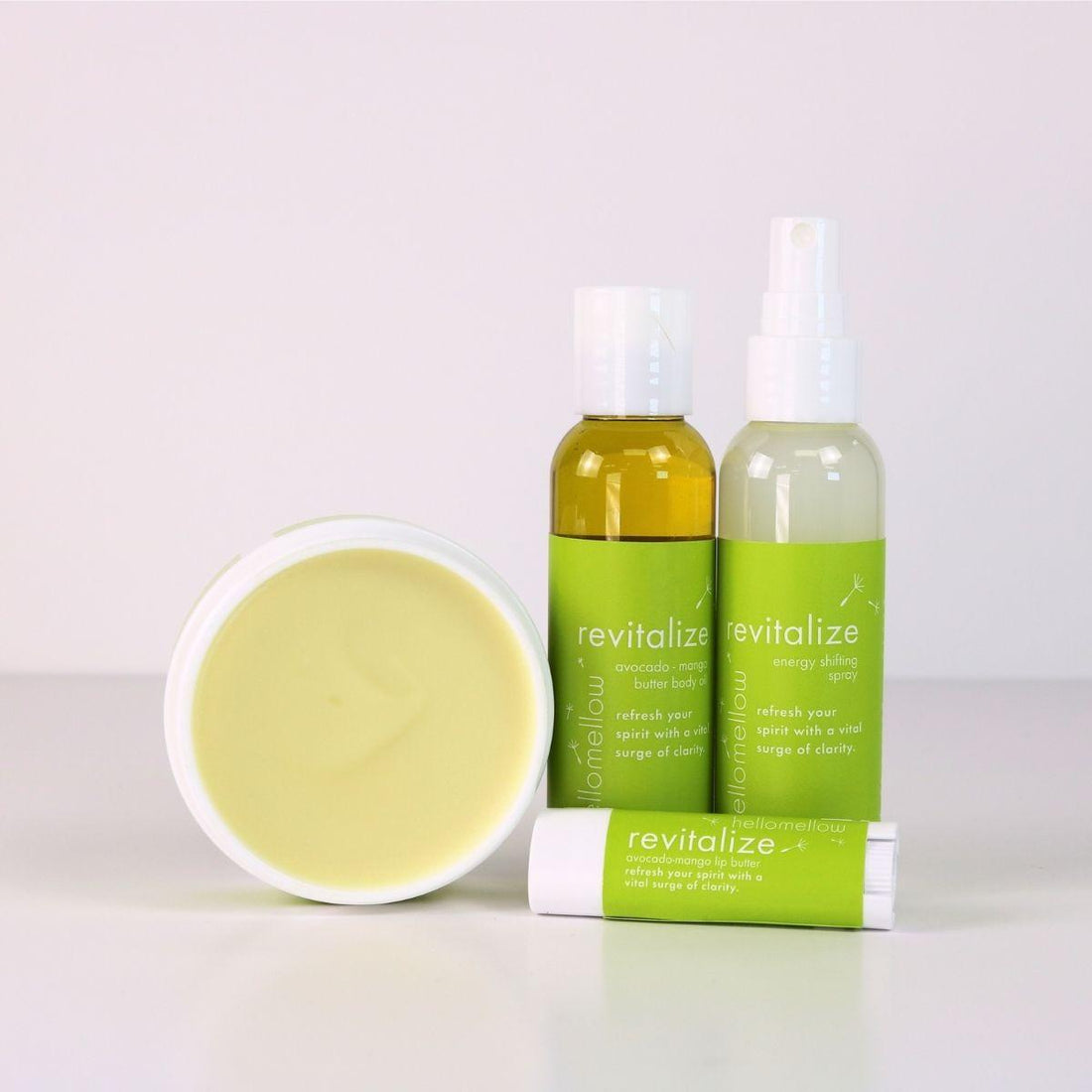 revitalize vacay vibe full product lineup with an open body butter, body oil, energy shifting aromatherapy spray, lip butter 