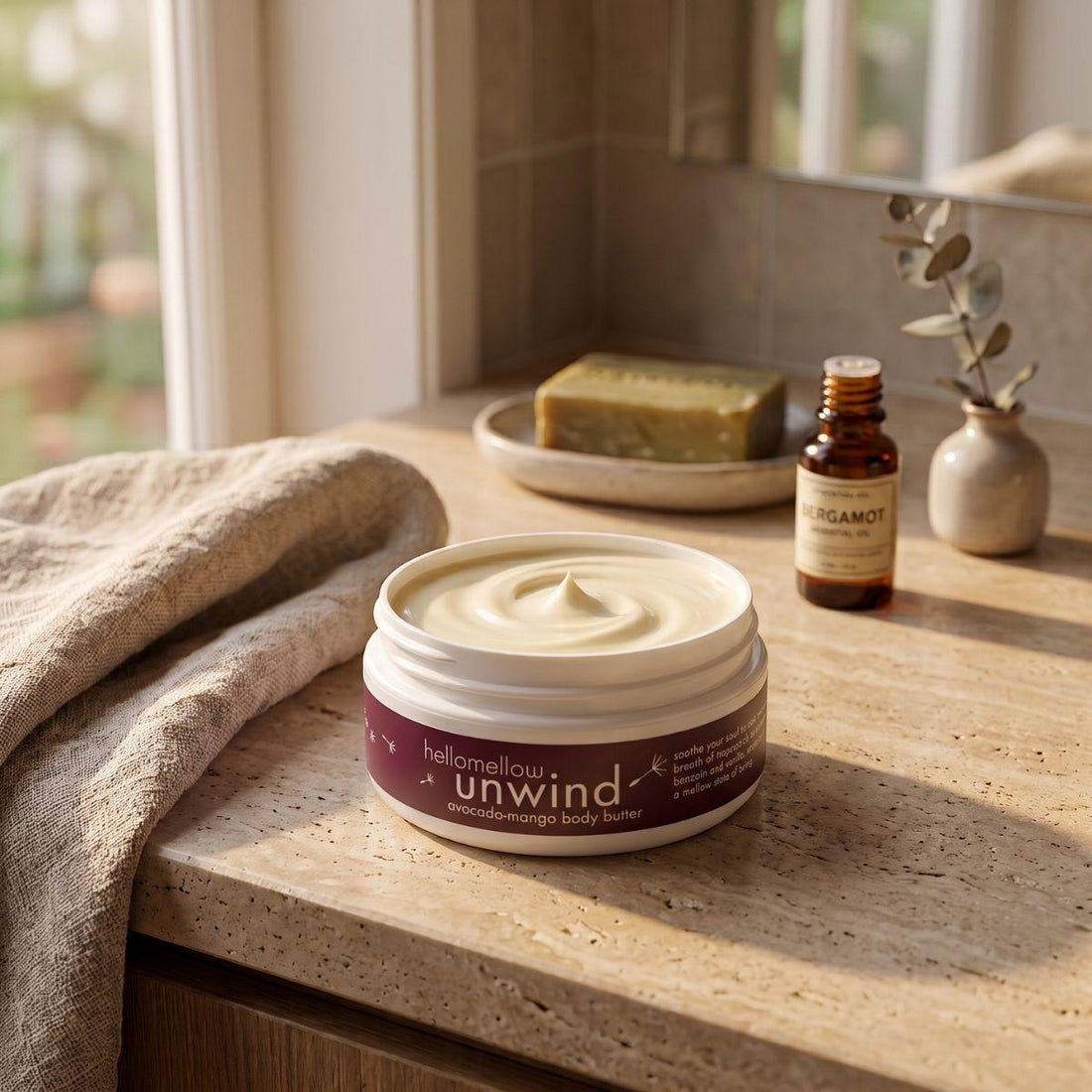 unwind body butter on a warm bathroom counter beside a folded towel