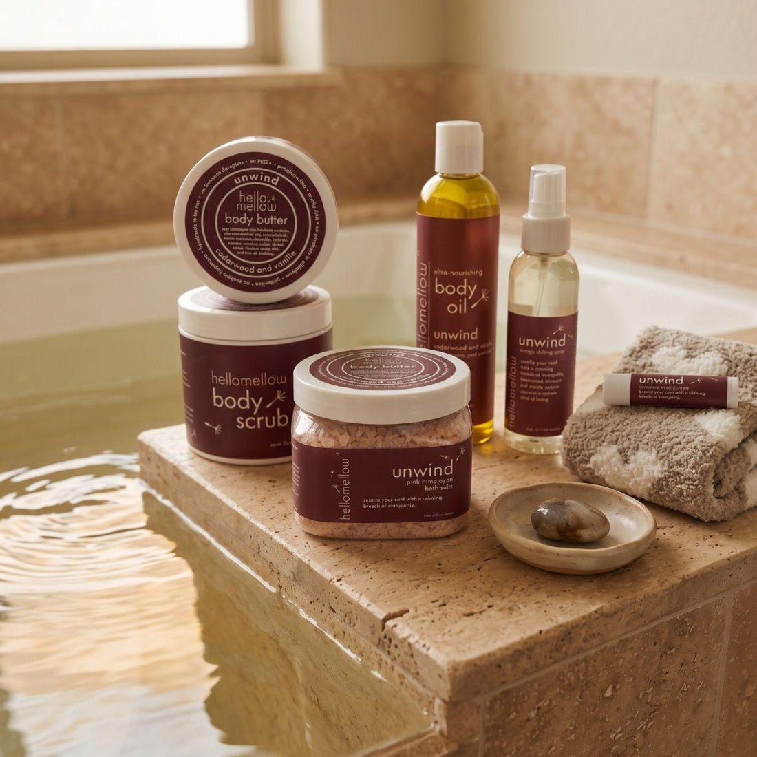 bath salts beside a warm bath with a folded towel and simple ceramic detail