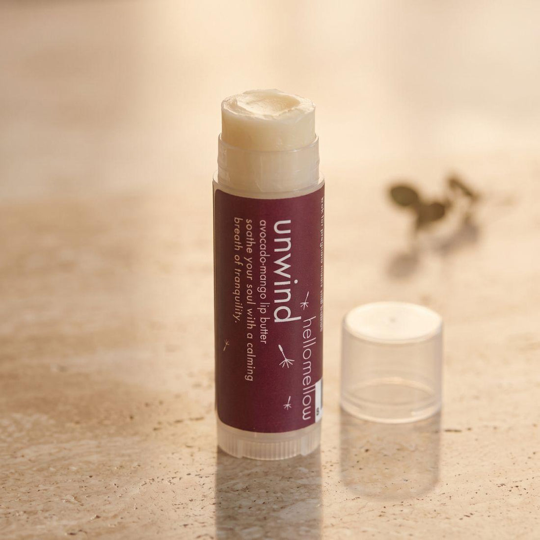 unwind lip butter shown open or ready for use in its real packaging