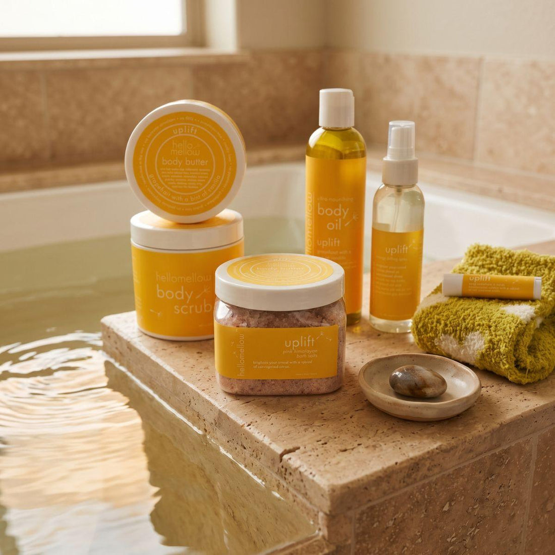 bath salts beside a warm bath with a folded towel and simple ceramic detail