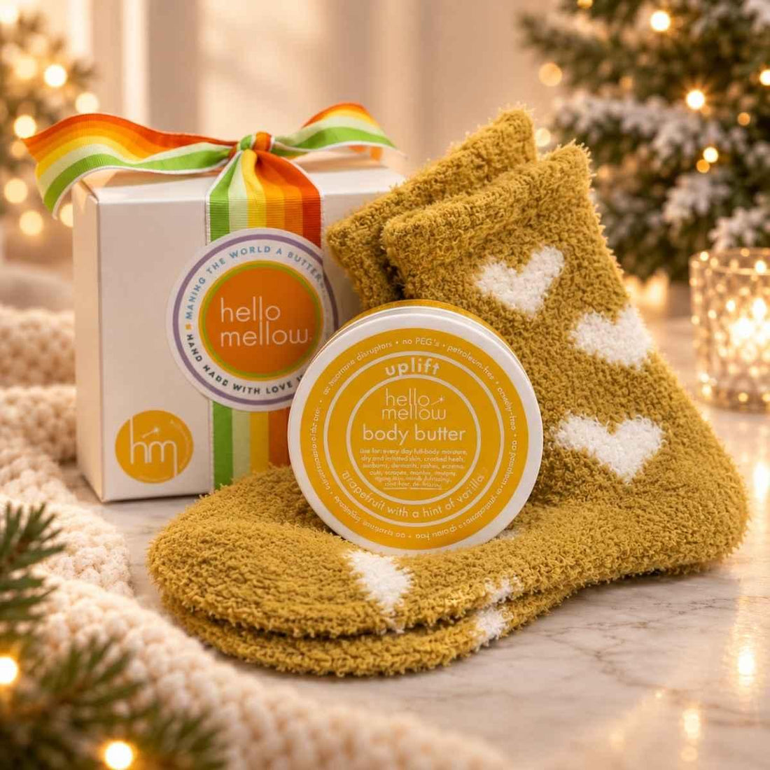 uplift 2 oz body butter and cozy sock gift wrapped in holiday setting