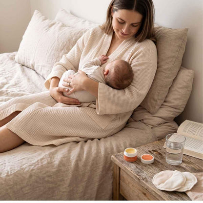 woman nursing baby with hellomellow preggo boobie butter